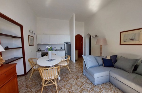 Cavo Apartment | In a beautiful private park with swimming pool and tennis court, with direct access to the beach, first-floor flat with lift with beautiful sea-view terrace. It consists of a nice living room with dining area, double sofa bed, walled kitchen : the living