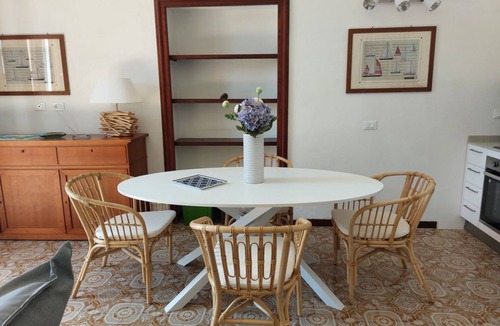 Cavo Apartment | In a beautiful private park with swimming pool and tennis court, with direct access to the beach, first-floor flat with lift with beautiful sea-view terrace. It consists of a nice living room with dining area, double sofa bed, walled kitchen : the living