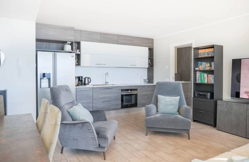 Perledo Apartment | In a panoramic position, modern apartment on the first floor of a new residence with SPA. Large windows frame the unique landscape of Lake COMO.This apartment has a beautiful terrace, with table and chairs and a sofa. The living room is a large open spac