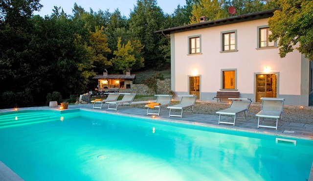 Ancient country villa with pool in the hills of Tuscany, surrounded by woods