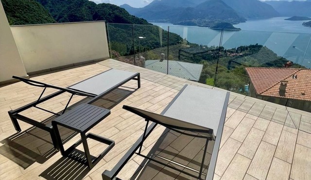 In a panoramic position, modern apartment on the first floor of a new residence with SPA. Large windows frame the unique landscape of Lake COMO.This apartment has a beautiful terrace, with table and chairs and a sofa. The living room is a large open spac